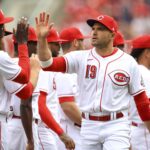 Cincinnati Reds' Joey Votto (19) high-fives teammates during player introductions prior to a baseball game against the Cleveland Guardians in Cincinnati, Tuesday, April 12, 2022. The Guardians won 10-5. (AP Photo/Aaron Doster)